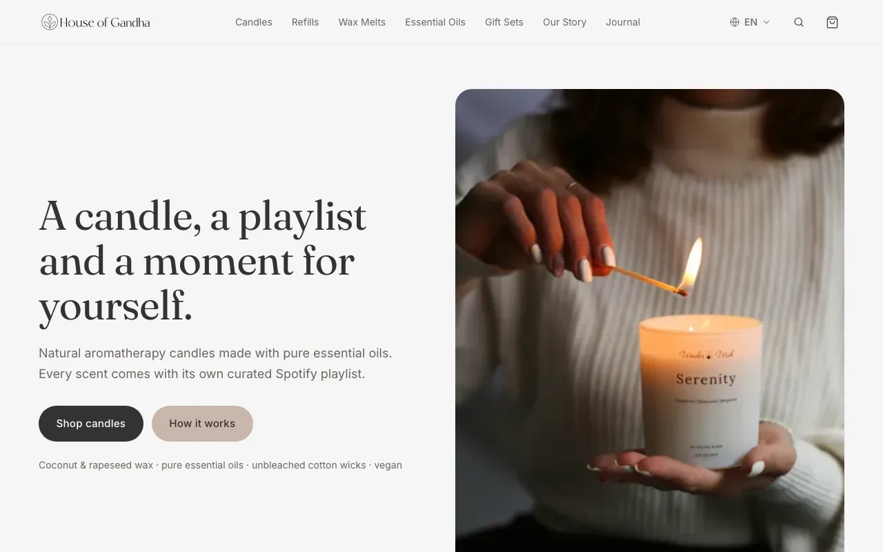 The House of Gandha homepage, a warm candle photo beside its headline